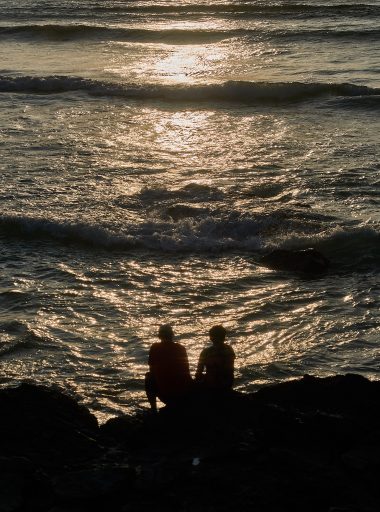 Two people watching the sea